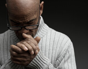 man praying to god Caribbean man praying with black grey background with people stock photo