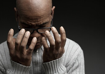 man praying to god Caribbean man praying with black grey background with people stock photo