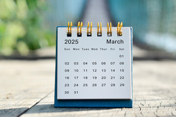 March 2025 white calendar with green blurred background. New year concept.