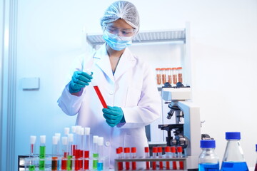 Science test tubes, laboratory equipment for new medical research, microbiology research with small pipettes in close-up. Asian and African female scientists in the laboratory, perfume samples