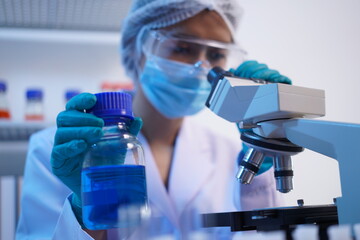 Fototapeta premium Science test tubes, laboratory equipment for new medical research, microbiology research with small pipettes in close-up. Asian and African female scientists in the laboratory, perfume samples