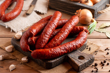 Smoked sausage on a wooden rustic board. Rustic table