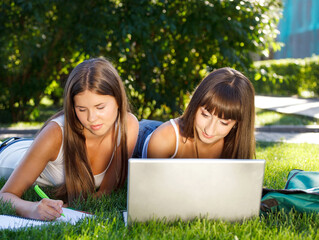 Happy young girls having fun using a computer