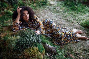 Fashion and beauty shooting a charming mixed race girl in a long dress