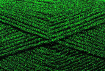 The texture of the wool blend yarn is dark green.