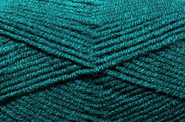 The texture of the wool blend yarn is dark turquoise.