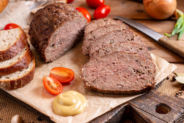 Tasty homemade ground baked meatloaf on wooden table. Food. Traditional czech meat loaf.