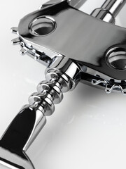 Glossy metal wine bottle opener isolated over the white background