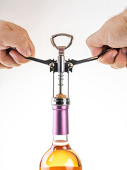 A man's hands opening a wine bottle on white background