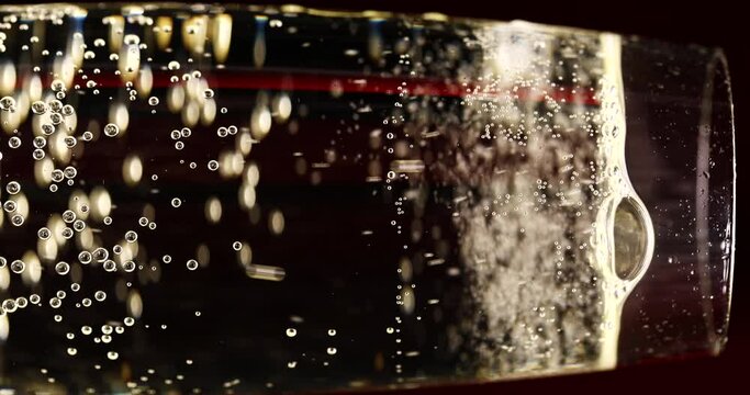 Glass of champagne on a black isolated background. Capturing the effervescence: Slow-motion, super macro shot showcasing delicate champagne bubbles gracefully rising in an elegant glass against a pris