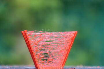 3D printed model with an issue that is called stringing which looks like a thin thread bridging...