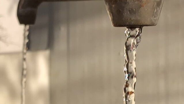 public mineral well in Germany, closeup of the faucet with running mineral water