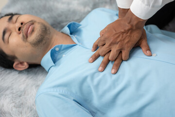 Emergency first aid CPR first aid man first aid man having heart attack or shock part of...