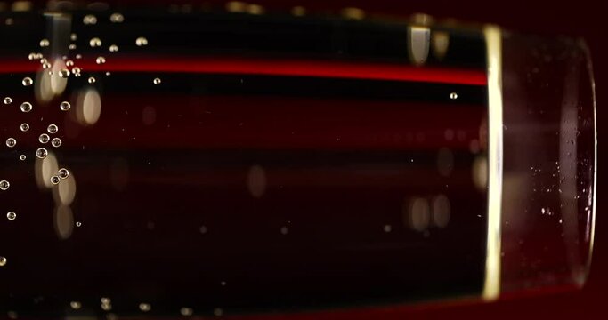 Glass of champagne on a black isolated background. Capturing the effervescence: Slow-motion, super macro shot showcasing delicate champagne bubbles gracefully rising in an elegant glass against a pris