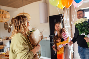 Young couple congratulates female blonde with her birthday