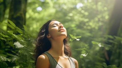Relaxed woman breathing fresh air in a green forest - obrazy, fototapety, plakaty
