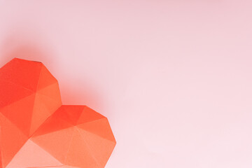 Big red paper heart in the corner of a pink background.