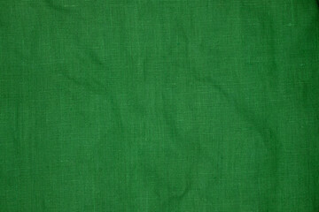 Green linen fabric texture. Sustainable and environmentally friendly textile. Copy space.