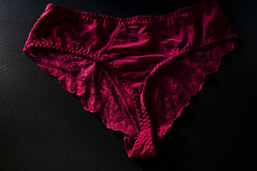 Red floral lace luxury elegant women high-waisted brief panty on black background. 