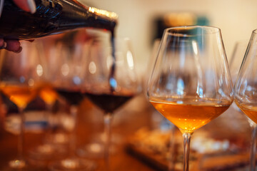 Glass goblets placed in rows on table during wine tasting procedure in restaurant
