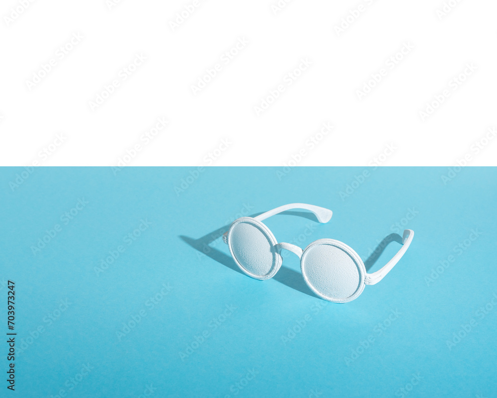 Wall mural White sunglasses on blue background. Creative minimal concept.