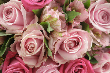 Naklejka premium A bouquet of roses, alstroemeria, hellebore in pink shades of color. Close-up. Floral background.
