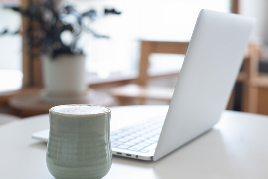 Close Up, Cup Of Coffee And Laptop Computer On White Table In Coffee Shop With No People, Copy Space For Business Background, Freelance Lifestyle