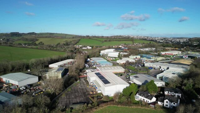 Yalberton, South Devon, England: DRONE VIEWS: An industrial estate on the outskirts of the town of Paignton featuring factories and warehouses as an example of urban creep / urbanisation (Clip 3).