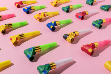 Colorful celebration pattern with party blower horns. Minimal party concept. Flat lay.