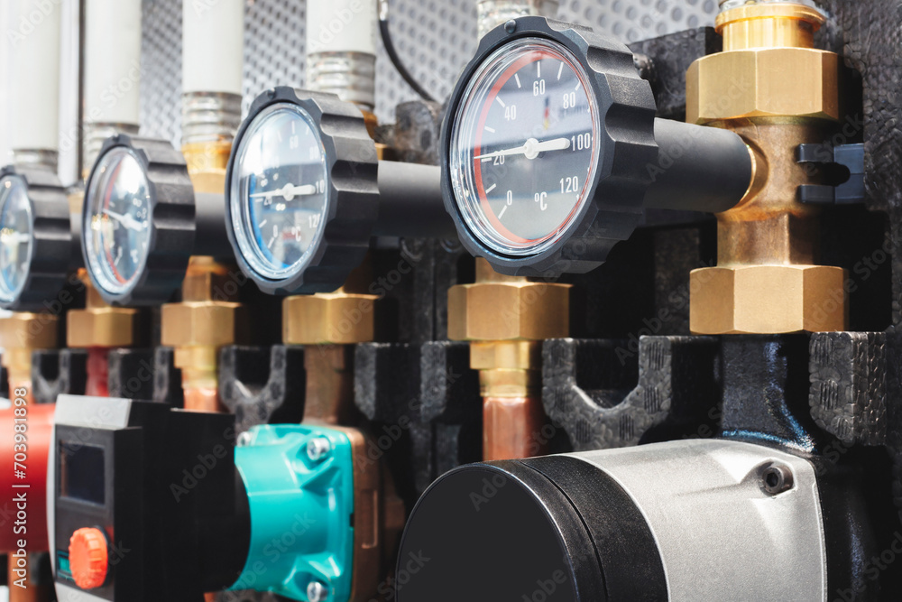 Poster pressure, temperature and flow sensors in an industrial boiler room. barometer in the heating system