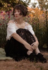 girl in a dress sitting on the ground