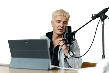 An adult male streamer records a podcast online using a microphone and a laptop. Transparent...