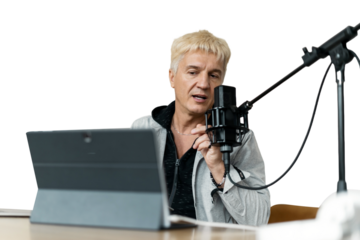 An adult male streamer records a podcast online using a microphone and a laptop. Transparent background.