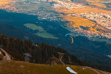 Alpine sunset or sundowner with paragliders at the famous Nordkette mountains near Innsbruck,...