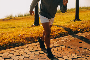 Athlete runner feet running on road, Jogging concept at outdoors. Man running for exercise..Athlete...