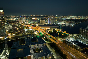 Fototapeta premium Aerial view of american highway junction at night with fast driving vehicles in Tampa, Florida. View from above of USA transportation infrastructure