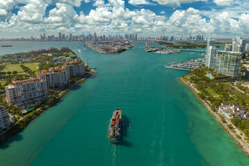 Aerial view of large container ship entering in Miami harbor main channel near South Beach....