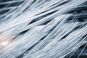 synthetic textile thread,  thread at industrial weaving manufacturing machine,  textile fabric...