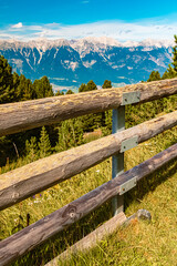 Fototapeta na wymiar Alpine summer view with details of a wooden fence at Mount Patscherkofel, Innsbruck, Tyrol, Austria