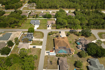 Aerial view of small town America suburban landscape with private homes between green palm trees in Florida quiet residential area