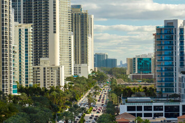 Aerial view of Sunny Isles Beach city with congested street traffic and luxurious highrise hotels...
