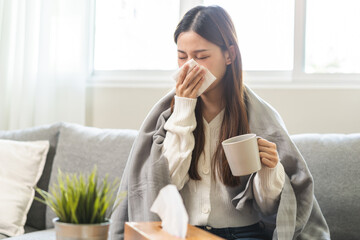 Sick, hurt or pain asian young woman have a fever, flu sore throat, drinking a mug of warm water,...