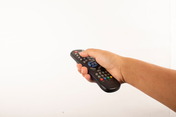 a man's hand holds a remote