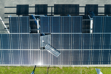 Destroyed by hurricane wind solar panels installed over parking lot canopy shade for parked cars for effective generation of clean energy. Damage from severe weather to Florida infrastructure
