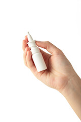 Hand holds a bottle of nasal drops isolated on white background.