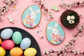 Easter gingerbread and eggs with seasonal flowers on pink background. Sweet Easter concept, greeting card
