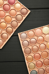 Pastel palette of eyeshadow on black background. Space for text