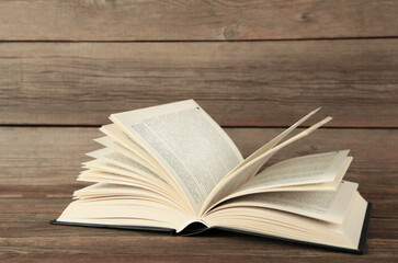 Open book on grey wooden background. Space for text