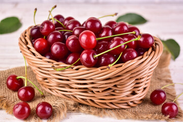 Fresh cherries in a basket on a white background.Close-up.
