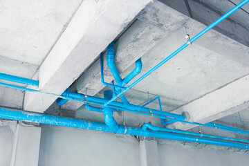 pvc water blue plastic pipe installing at ground floor roof in under construction building - obrazy, fototapety, plakaty